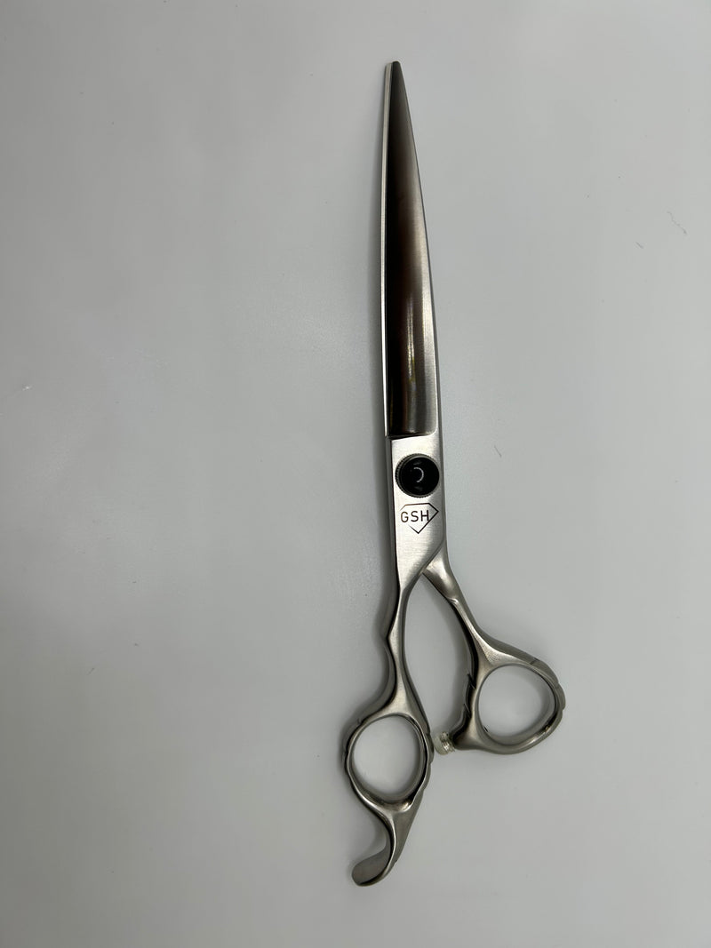 Left-handed 7-inch Curve Groomer Supply House shears with ergonomic handle and sharp blades for precise grooming tasks.